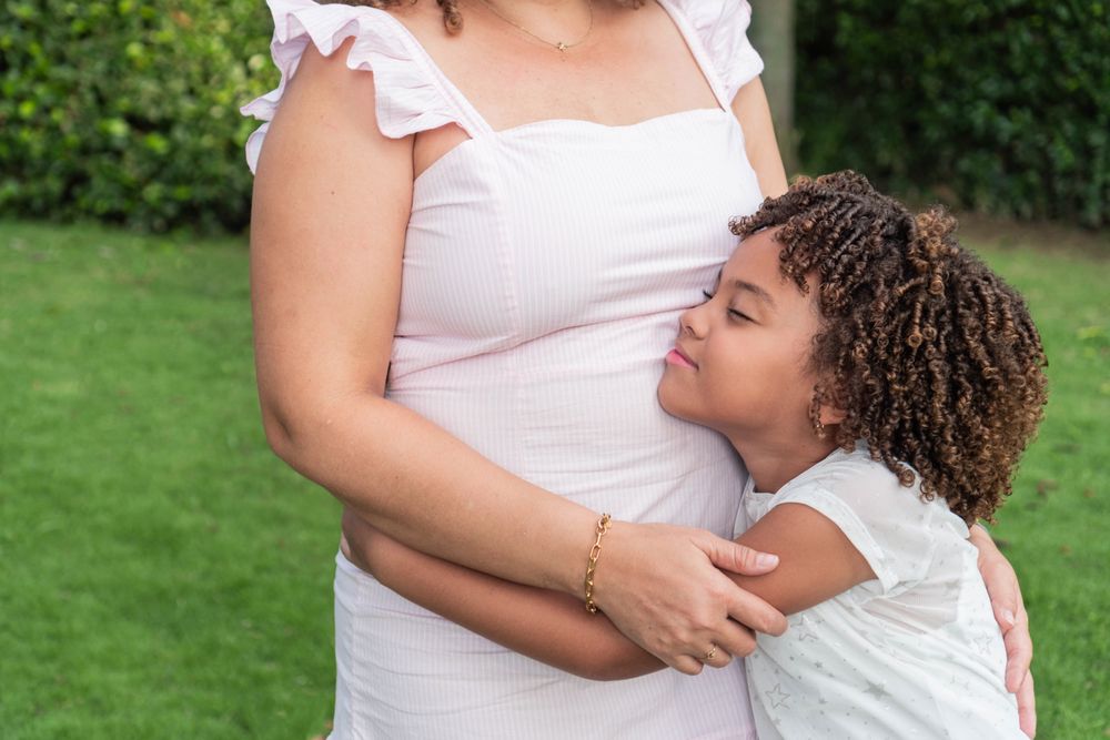 Girl hugging her mother in the open air