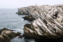 Rocky formations in the island of Baleal on the Atlantic coast in a foggy day. Peniche, Portugal