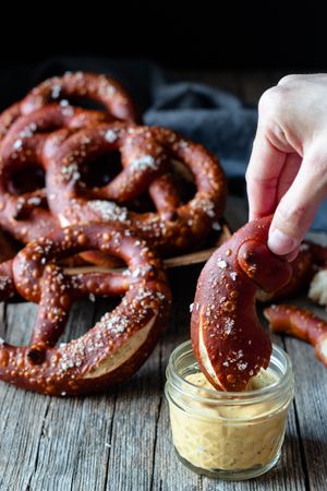 Faceless person eating delicious pretzels