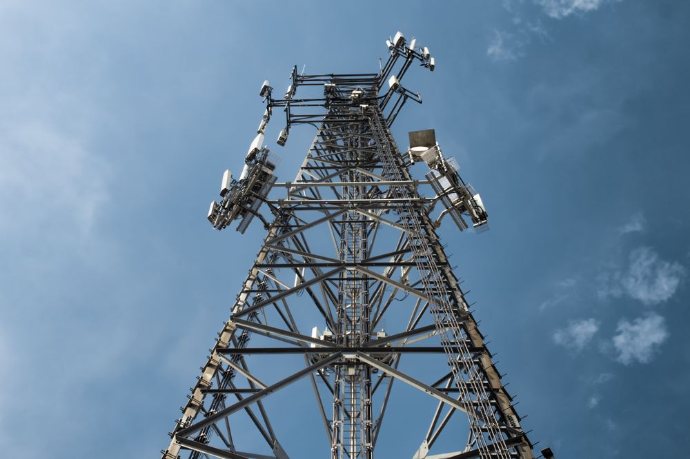 High Steel Telecommunications Tower Against a Clear Blue Sky