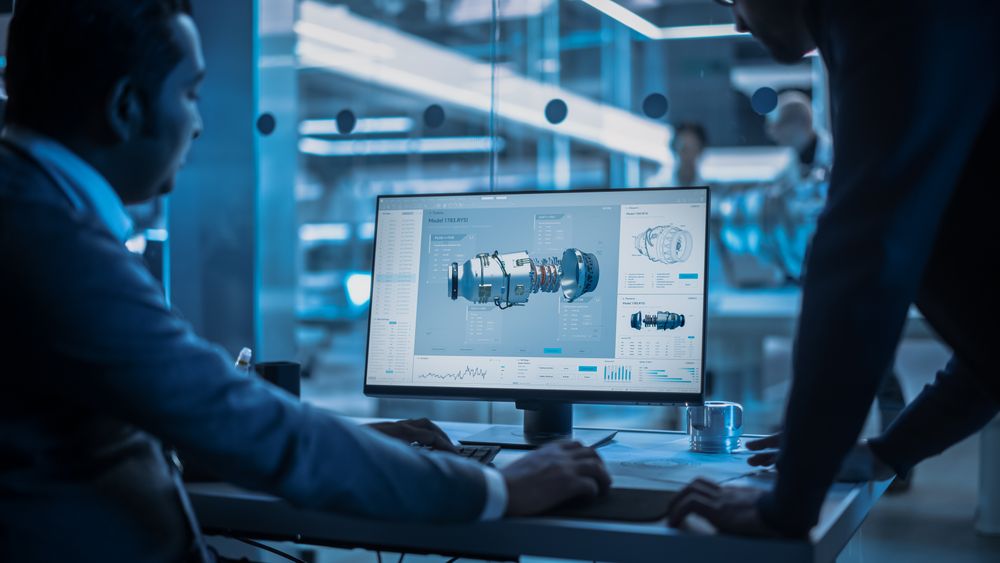 Two Turbine Engine Developers Working on Programming a Prototype Jet Engine on Desktop Computer.