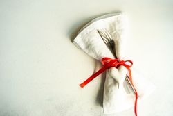 Romantic table setting with red ribbon