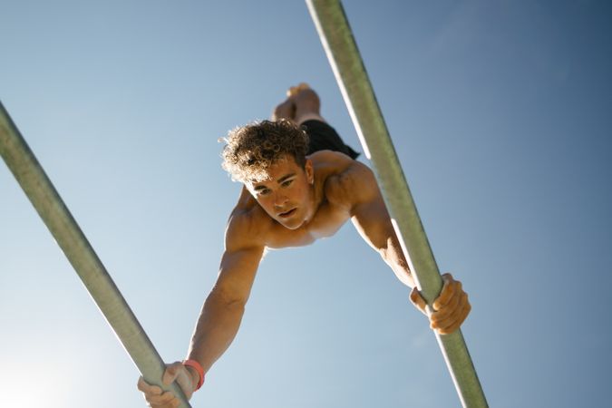 Strong young sportsman doing calisthenics