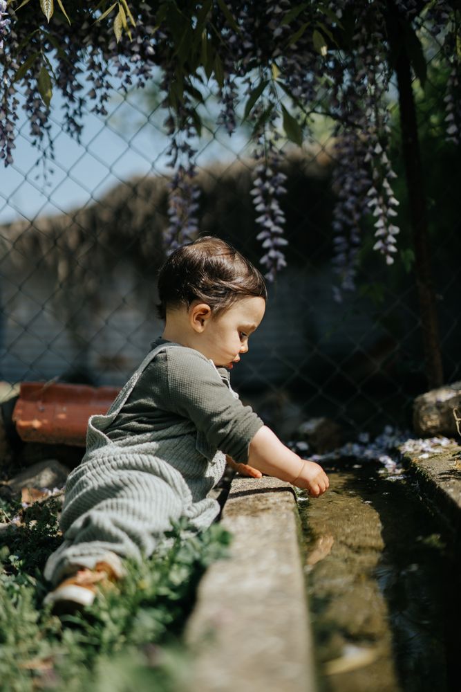 Side view of toddler exploring garden