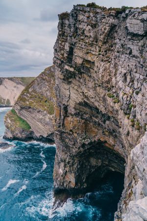 Sea waves crashing near cliff