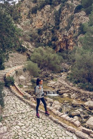Female tourist enjoying view of river in mountains