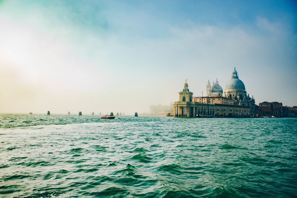 Waves on water surface and old building on shore