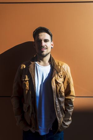 Confident guy leaning on wall