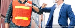 Construction site worker and foreman wearing hygiene face mask elbow bump greeting, banner 4O9rL0