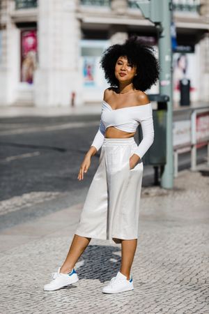 Young stylish female walking outdoors