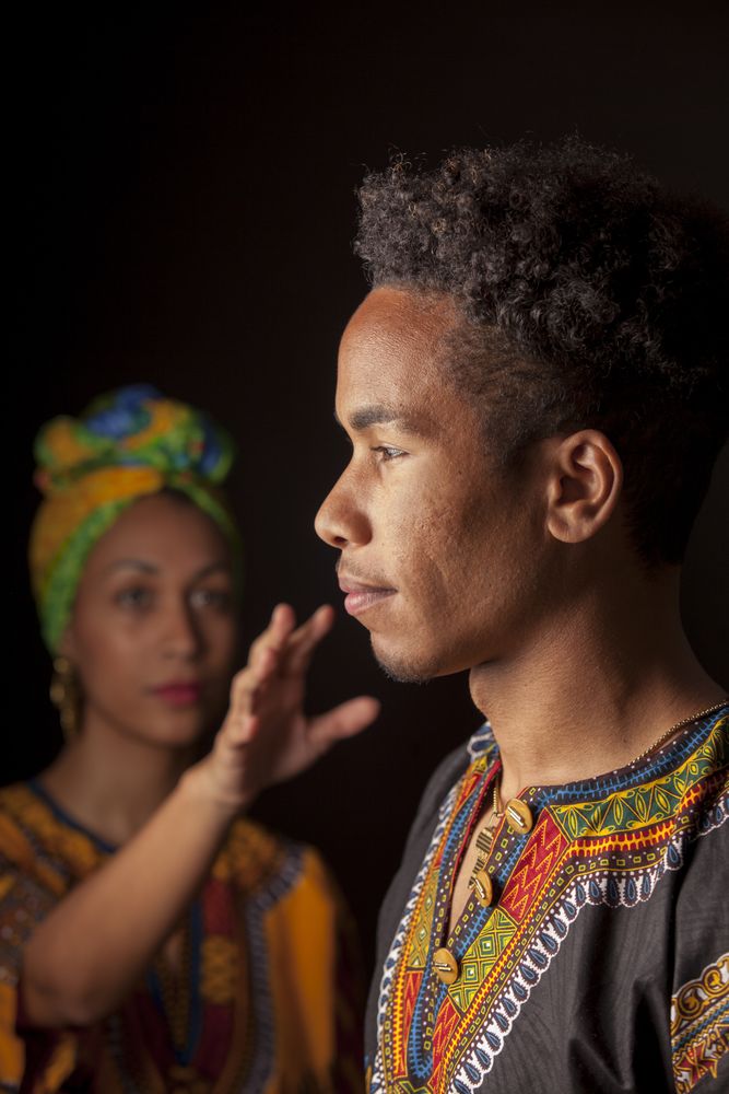 Woman pulling hand to face of man