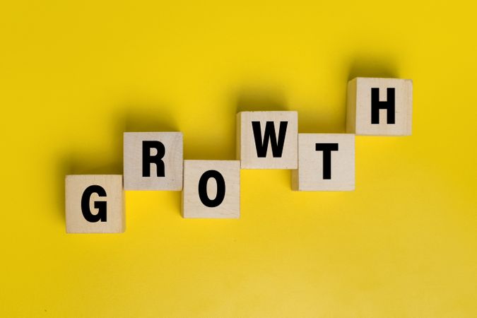 growth word on wooden blocks isolated on yellow background