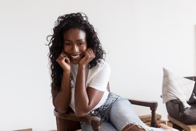 Portrait of smiling Black woman in her apartment