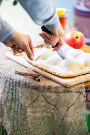 Person cutting apple cake dessert