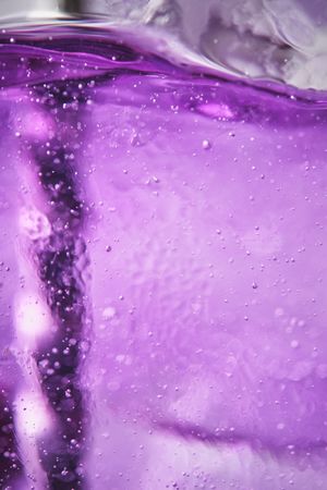 Ice with lilac colored tonic