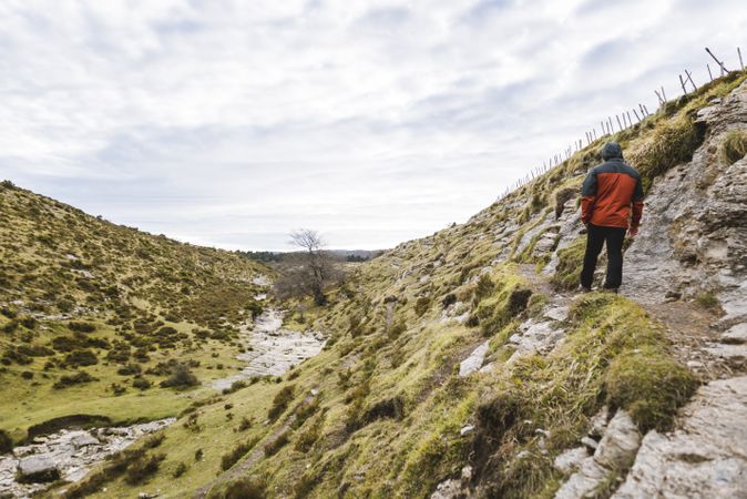 Man walking on hill near valley