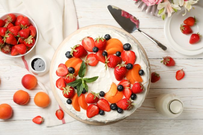 Composition with delicious berry cream cake on wooden table. Tasty dessert