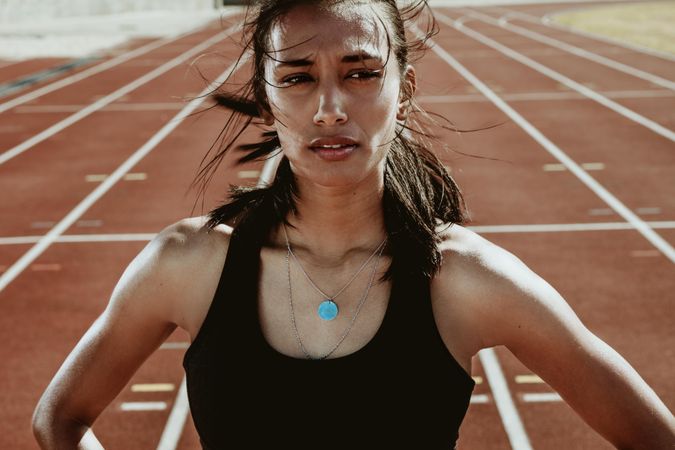 Close-up of a fit woman after run on stadium race track