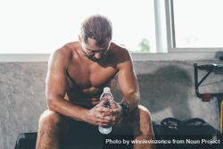 Athletic man resting after exercise at the gym 5rWzP4
