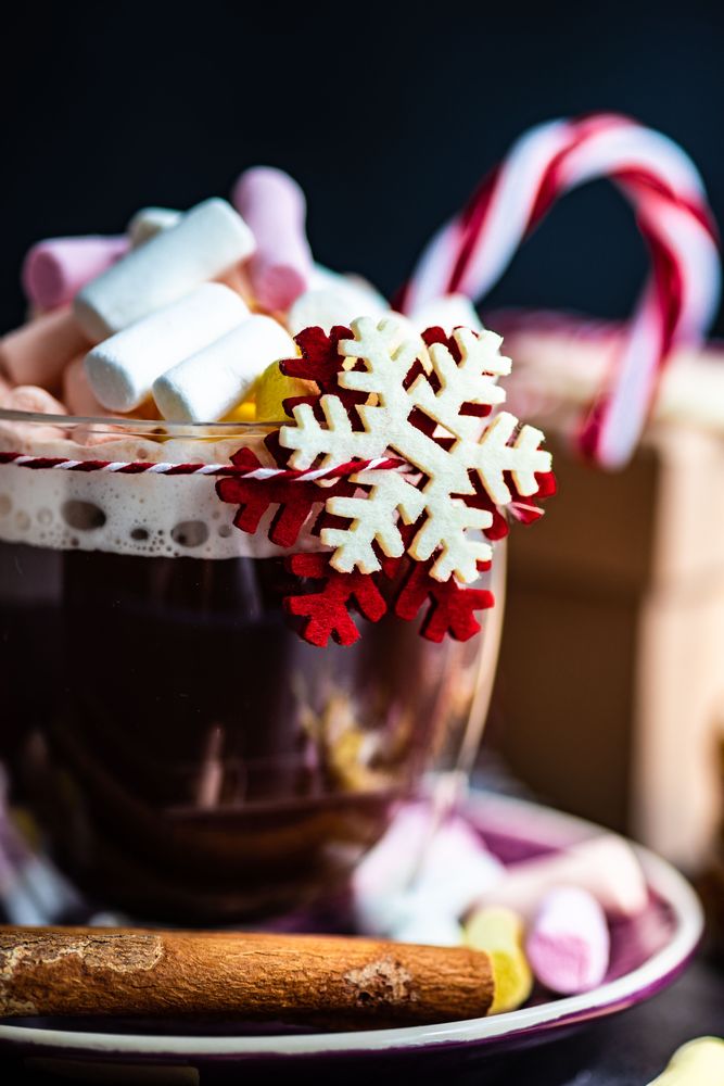Close up of marshmallow hot chocolate on table with snowflake decoration