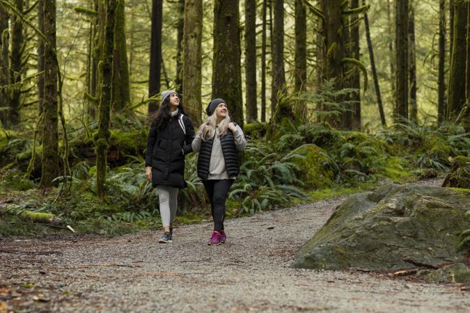 Young female and woman looking up and to the right in a forest