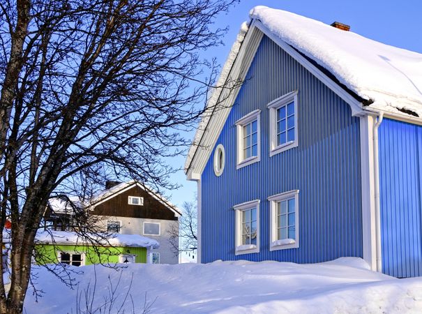 Blue cottage in winter countryside