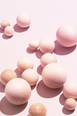 Wooden pink balls on baby pink background