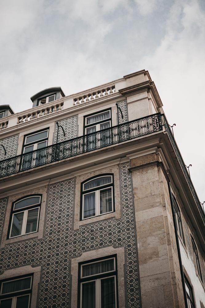Corner of building against cloudy sky