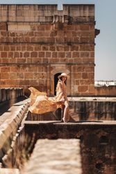 Stylish female on old bridge