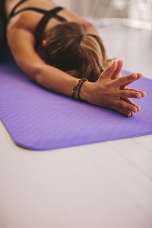 Female doing warm up on yoga mat