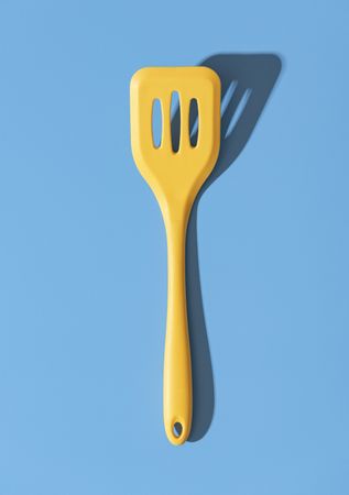 Silicone spatula minimalist on a blue table