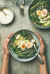 Female hand’s holding healthy lunch bowl
