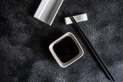 Dark Asian table setting with chopsticks