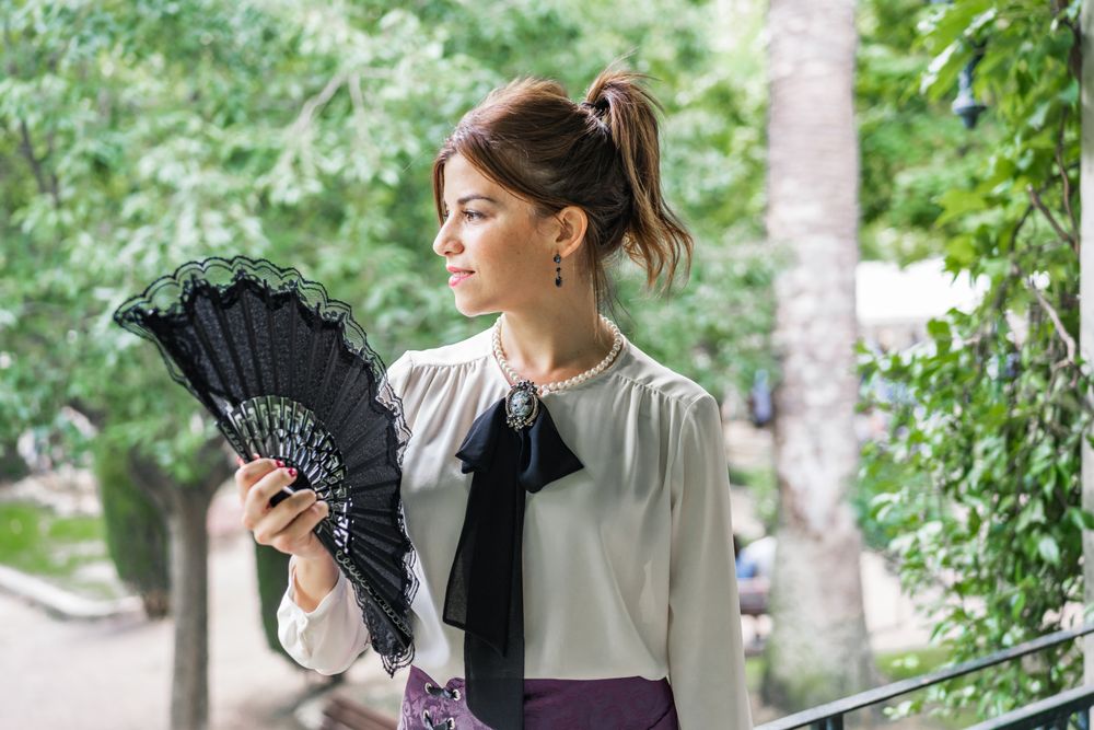 Woman with retro fan in park