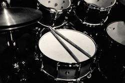 Drum set on stage in blue neon spotlights