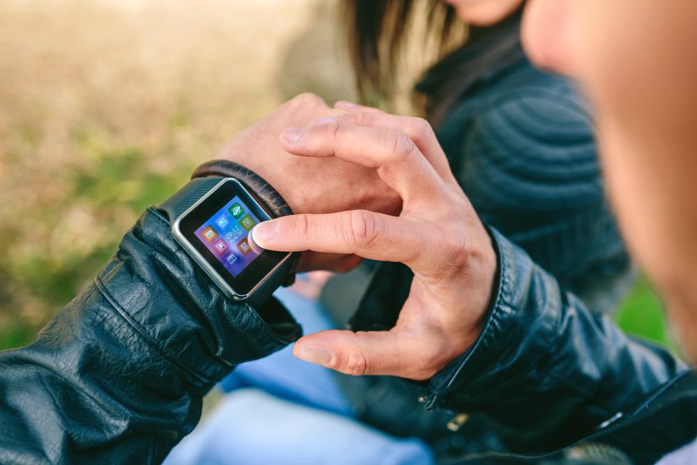 Unrecognizable young man using his smartwatch