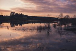 Cloudy evening sky over calm lake