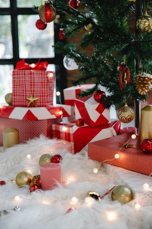 Gift boxes and ornaments under Christmas tree indoor