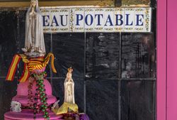 Religious statue on pink fountain