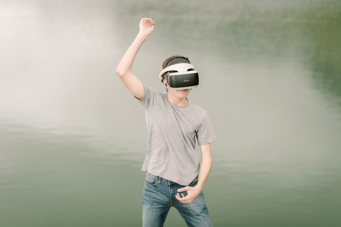 Young teenager with virtual reality glasses outdoors