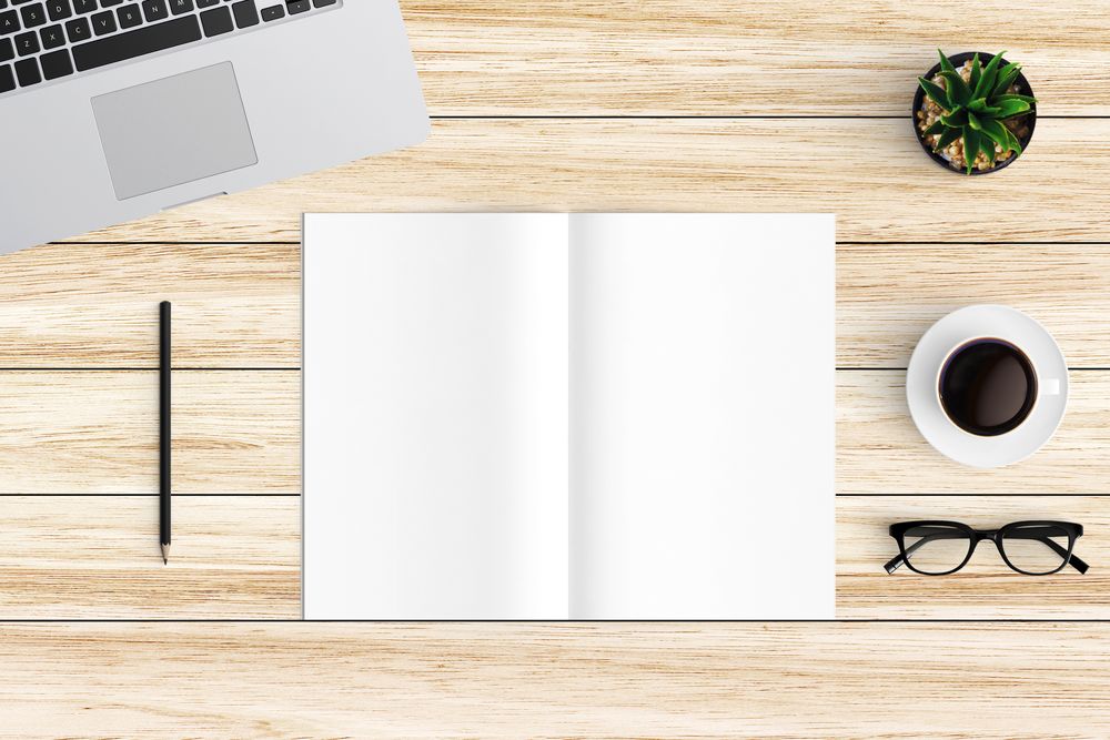 Modern workspace with coffee cup, smartphone, paper, notebook, tablet and laptop copy space