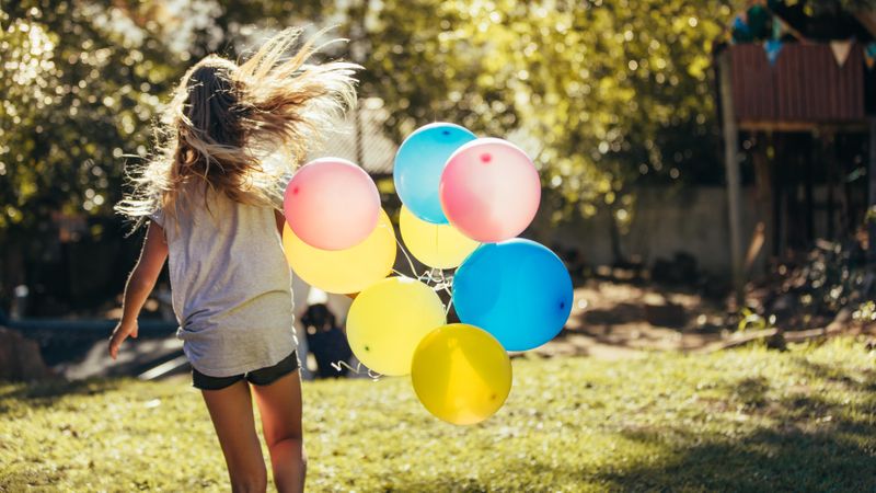 Girl having fun outdoors with balloons