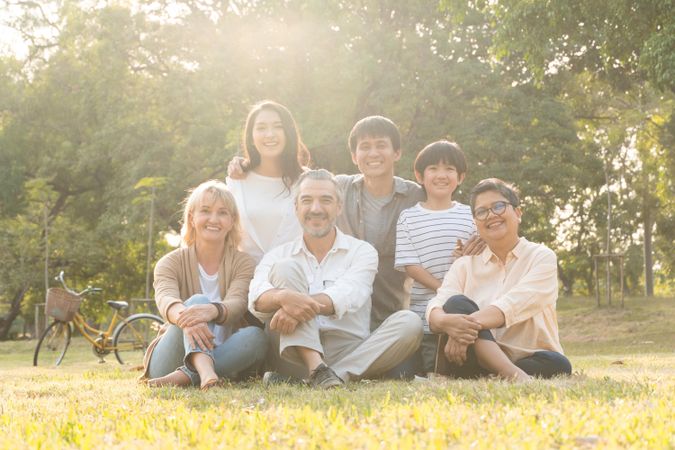 Multi-ethnic group of people sitting in the park together