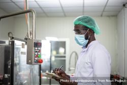 Black man performing inspection in a factory bEME1b
