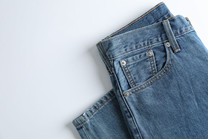 Jeans on light background, space for text