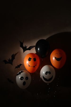 Different balloons on dark background. Halloween concept
