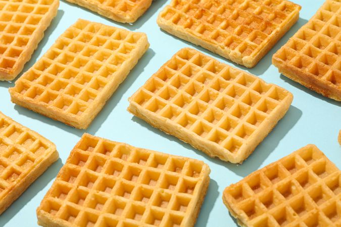 Flat lay composition with belgian waffles on color background