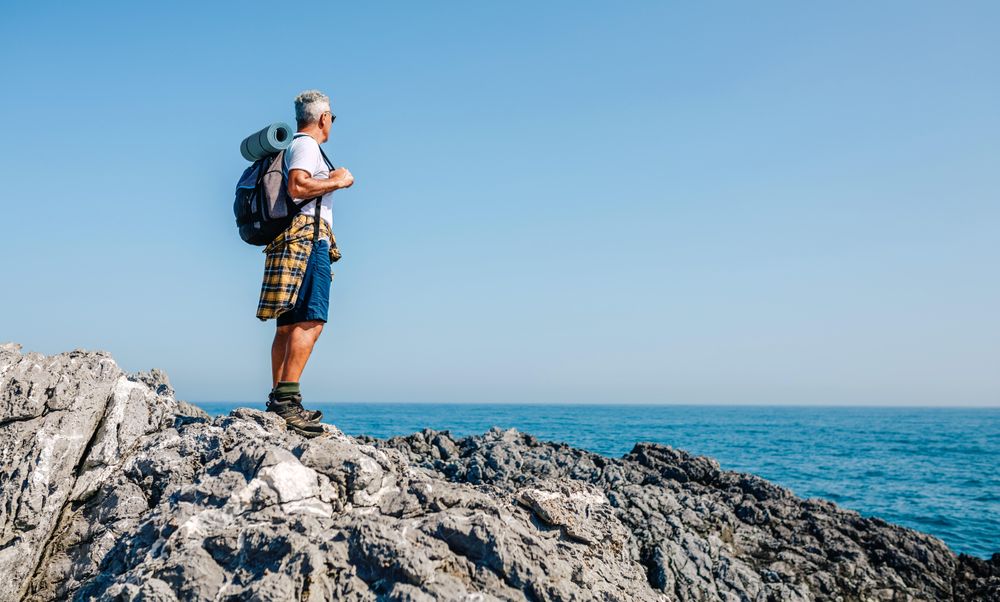 Mature man enjoying view on an ocean hike
