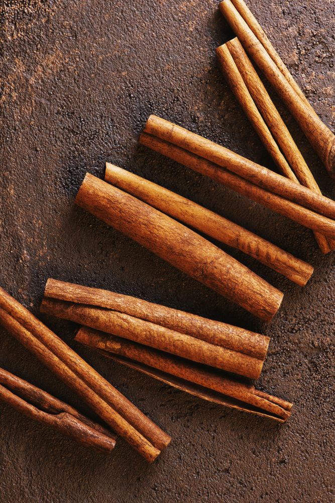 Cinnamon sticks on brown background