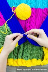 Woman knitting colorful shirt 0KQOV4